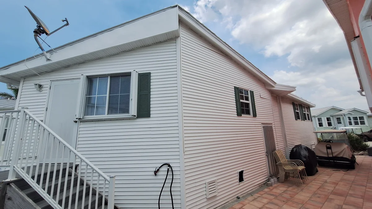 White siding and green shutters on the same Nettles Island home