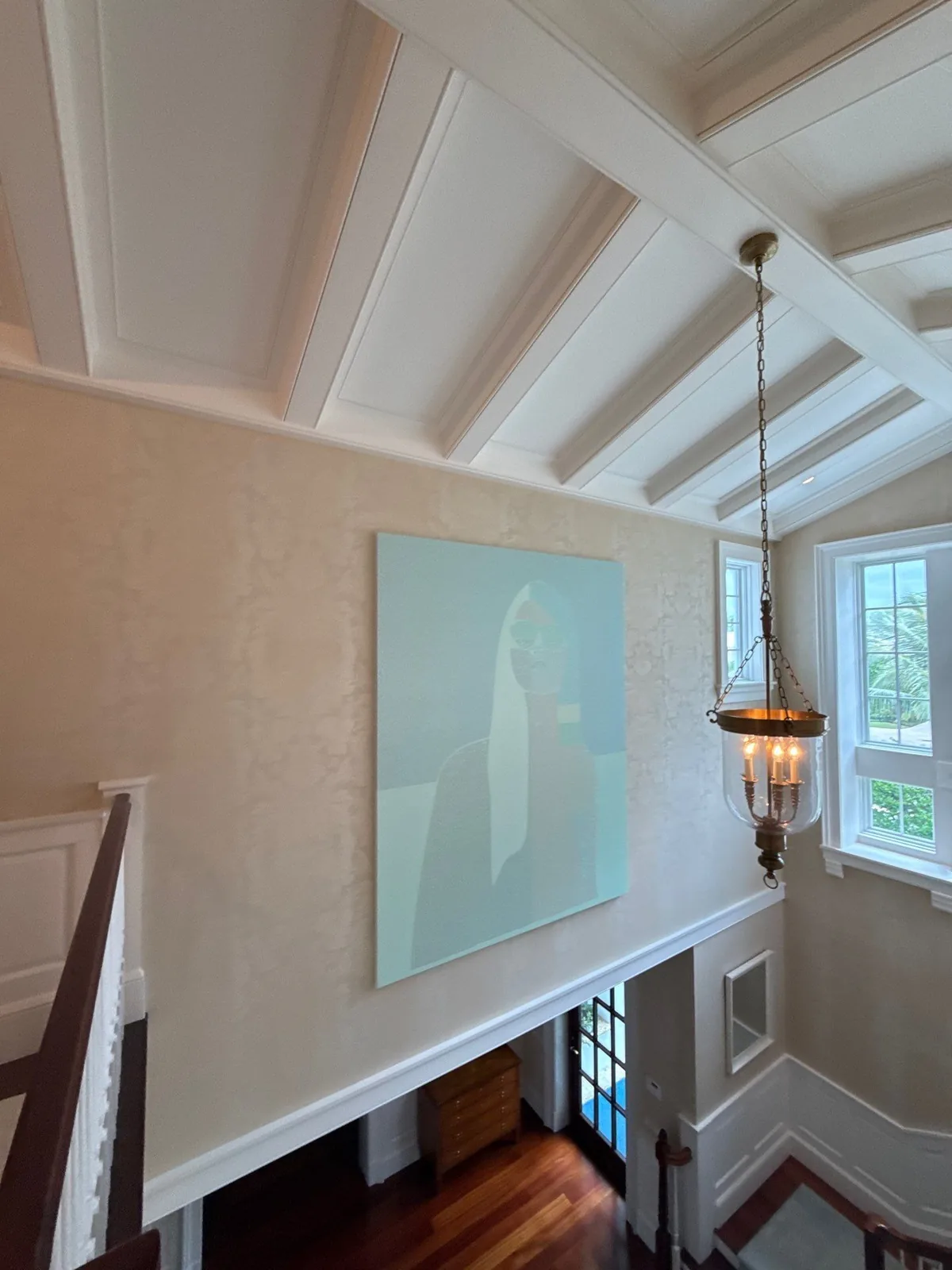 Interior Painting in Palm Beach, Florida. Two-storey stair hall with white coffered beam ceiling, textured cream walls, white trim and a hanging lantern.