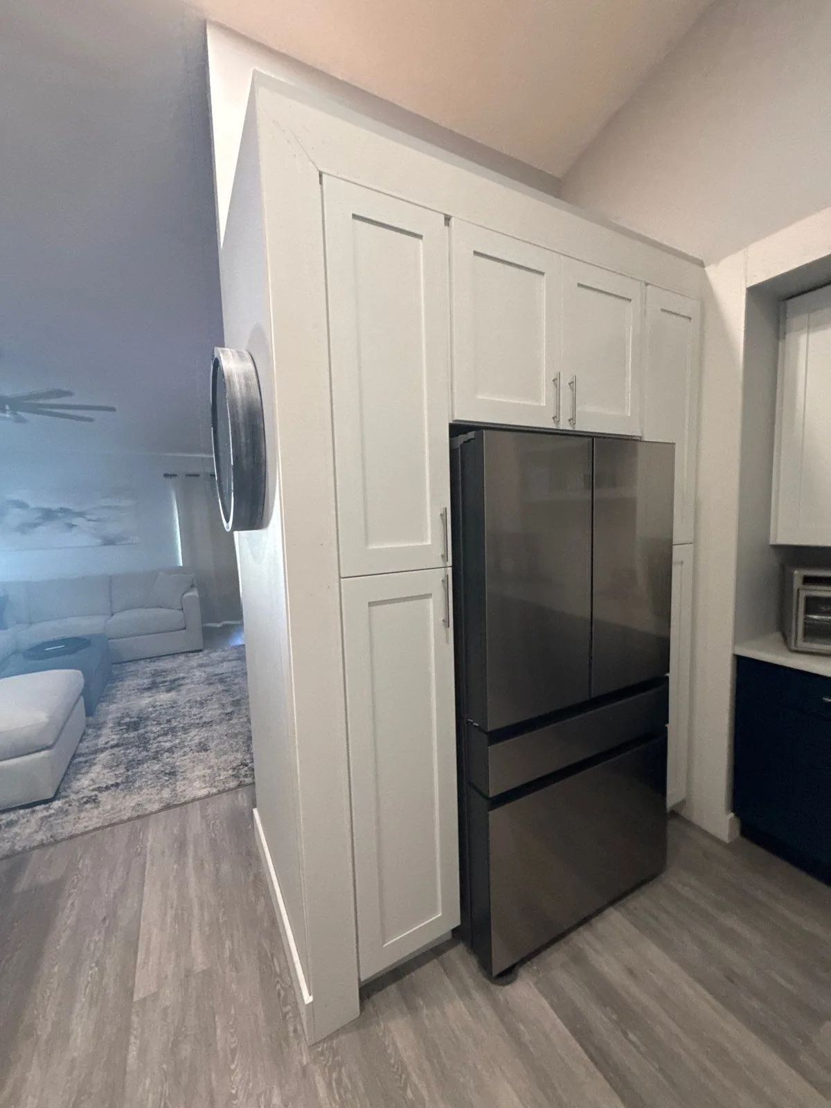 Cabinet Refinishing in Port Saint Lucie, Florida. White shaker pantry cabinetry built around a stainless french-door refrigerator.