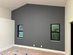 dern residential interior with a charcoal gray accent wall and white trim expertly finished.